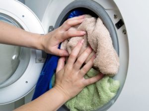 overloading the washing machine drum with laundry