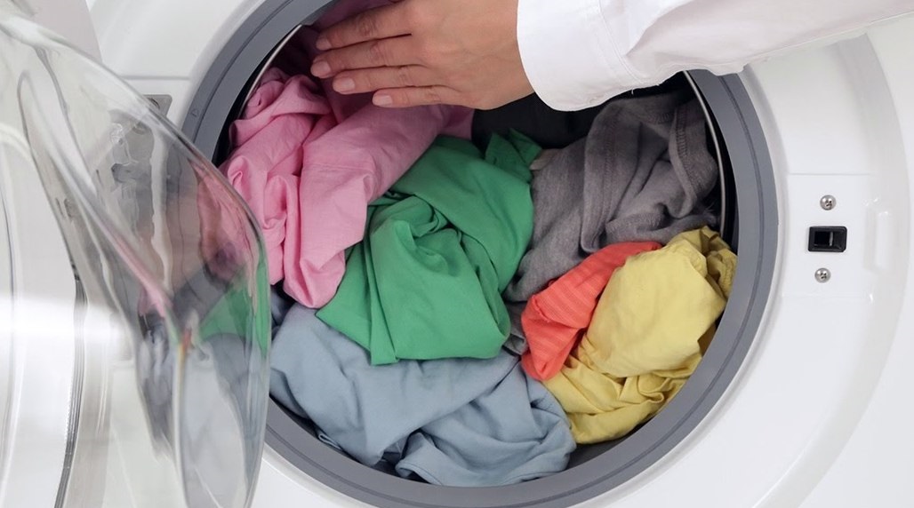 loading laundry into the drum