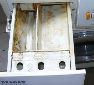 How to clean the powder compartment in a washing machine from scale?