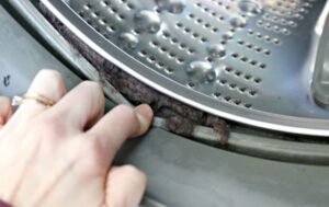 How to clean dirt under the cuff in an LG washing machine?