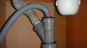 Inserting a washing machine drain into a plastic pipe