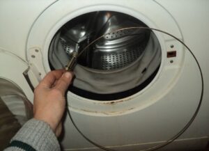 How to put a spring on a washing machine drum