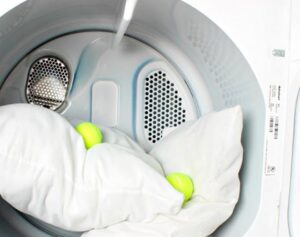 Is it possible to dry a feather pillow in a dryer?