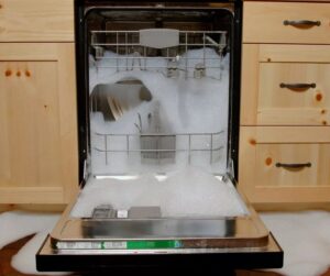 Why is foam leaking from my dishwasher?