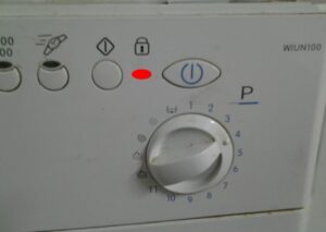 The red lock on the Indesit washing machine is on