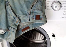 Should I use a spin cycle when washing jeans in a washing machine?